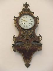 Antique gilded wall clock in historical Carmelite Church in Mdina