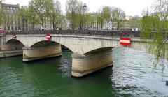 Pont de l'Archevêché over the Seine River in Paris with historic buildings in the background