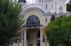 Le Palais Lumière in Évian-les-Bains, showcasing its yellow and white stone façade with a restored dome.