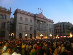 Public gathered at Plaça Sant Jaume waiting for projections on the facade of Casa de la Ciutat during La Mercè 2013 in Barcelona.