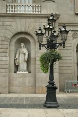 sculpture under classical portico with four columns