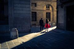 Fashionable woman dressed in red illuminated by a ray of light.