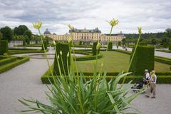 Drottningholm Palace with lush gardens and cloudy sky