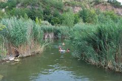 People swimming in the deep pond at Růženin quarry