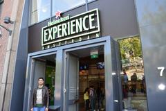 Heineken Experience building in Amsterdam with people walking nearby