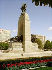 Poppies laid at a World War memorial with 'Lest We Forget' inscription