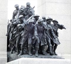 Front view of the National War Memorial of Canada with bronze statues and archway