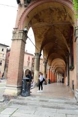 Piazza Santo Stefano in Bologna with historic buildings and people walking