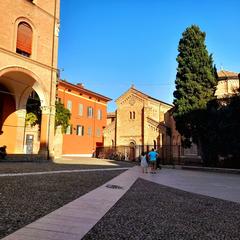 Piazza Santo Stefano in Bologna with historic buildings and tourists