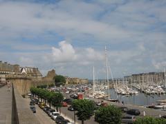 sailing boats moored at Bassin Vauban with ramparts promenade in Saint-Malo