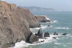 distant view of Point Bonita Lighthouse with ocean and cliffs