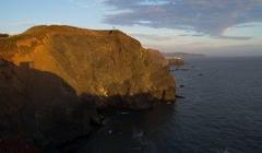 Cliff in the Marin Headlands at sunset with Point Bonita in the background