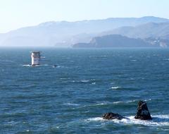 Mile Rocks lighthouse with Golden Gate Bridge in background