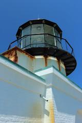 View of Point Bonita Lighthouse with reddish rust, sky, and lighthouse paint