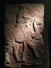 Ancient stone relief depicting a dromedary rider from 10th century BC