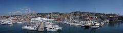 Panoramic view of Genoa port with boats and buildings