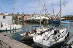 a sunny panoramic view of Genova's coastline with historic buildings and the Mediterranean Sea