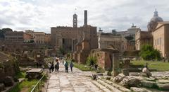 Trajan's Forum in Rome with ancient ruins under a partly cloudy sky