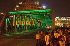 Waibaidu Bridge in green with crowds of tourists