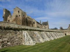 Aberdour Castle with stone buttresses supporting an ageing wall in the foreground