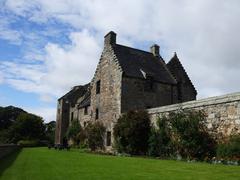 Aberdour Castle on a sunny day with green lawns and trees