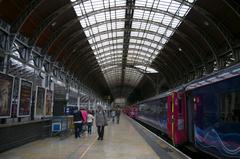 interior view of Paddington Station with iconic arched roof and directional banner on the floor