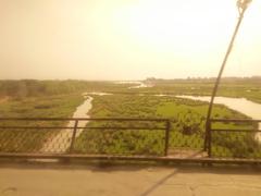 Serene landscape of river Jhelum with railway carriage in Pakistan