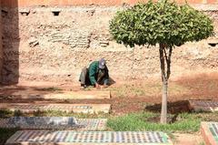 African people maintaining grounds around tombs