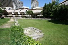 Jardin des Vestiges in Marseille with a grassy area and ancient port relics