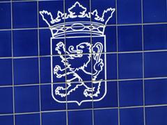 Monument of the Elf Cities Tour in Friesland near Giekerk, blue and white tiled bridge depicting figure skaters