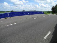 Elf-Städte-Tour monument in Friesland near Giekerk, a bridge covered with blue and white tiles showing ice skaters