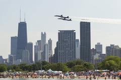 Chicagoans enjoy the sun at North Avenue Beach while Blue Angels fly overhead