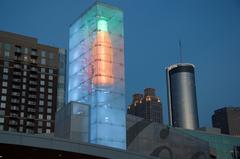 view of lighted Coca-Cola bottle atop World of Coca Cola building in Atlanta