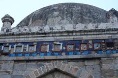 Remains of glazed blue tile work outside the Seesh Gumbad