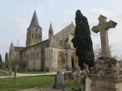 stone building facade with cross in Aulnay, France