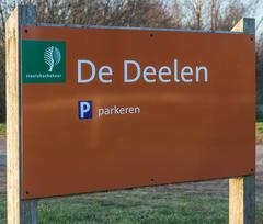 Information board on a walking trail through low moorland marshes in De Deelen