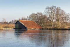 Boat house in low moorland marshes De Deelen