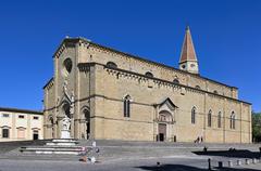 Facade of Arezzo Cathedral in Italy with a clear sky in the background