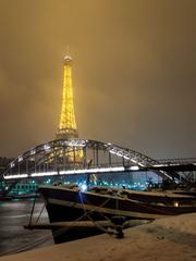 Eiffel Tower with snow, Passerelle Debilly, and boat