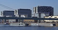 River cruise ship Amadeus Diamond sailing under Severins Bridge in Cologne with Crane Houses in the background