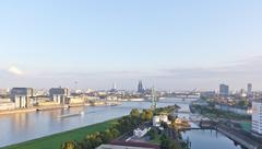 Hot air balloon flight over Cologne featuring Deutz Harbour, swing bridge, crane houses, and Severins Bridge