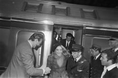 Melina Mercouri arriving at CS Amsterdam holding a Greek flag and wearing a beret