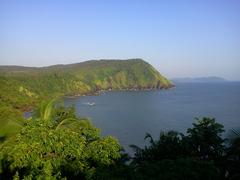 Canaguinim beach in Goa, India with lush greenery and clear blue skies