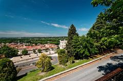 Panoramic view of Cathédrale Notre-Dame des Doms d'Avignon, gilded statue of Virgin Mary, and Place du Palais from Jardin des Doms