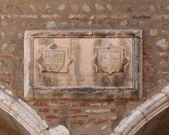 Campo Santo stone relief with coats of arms and inscription in Perpignan