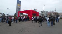 people gathered at Plaza Lima Sur watching a football match on a big screen