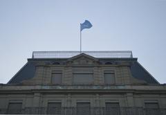 United Nations flag flying over Palais Wilson facade in Geneva