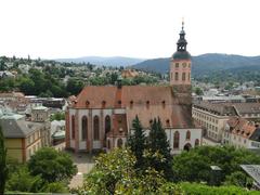 view of Baden Baden with green hills and buildings under a cloudy sky