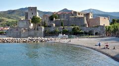 view of Collioure with colorful buildings and a lighthouse along the coast