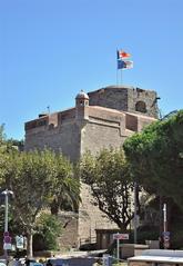 Collioure Royal Castle with waterfront, boats, and mountains